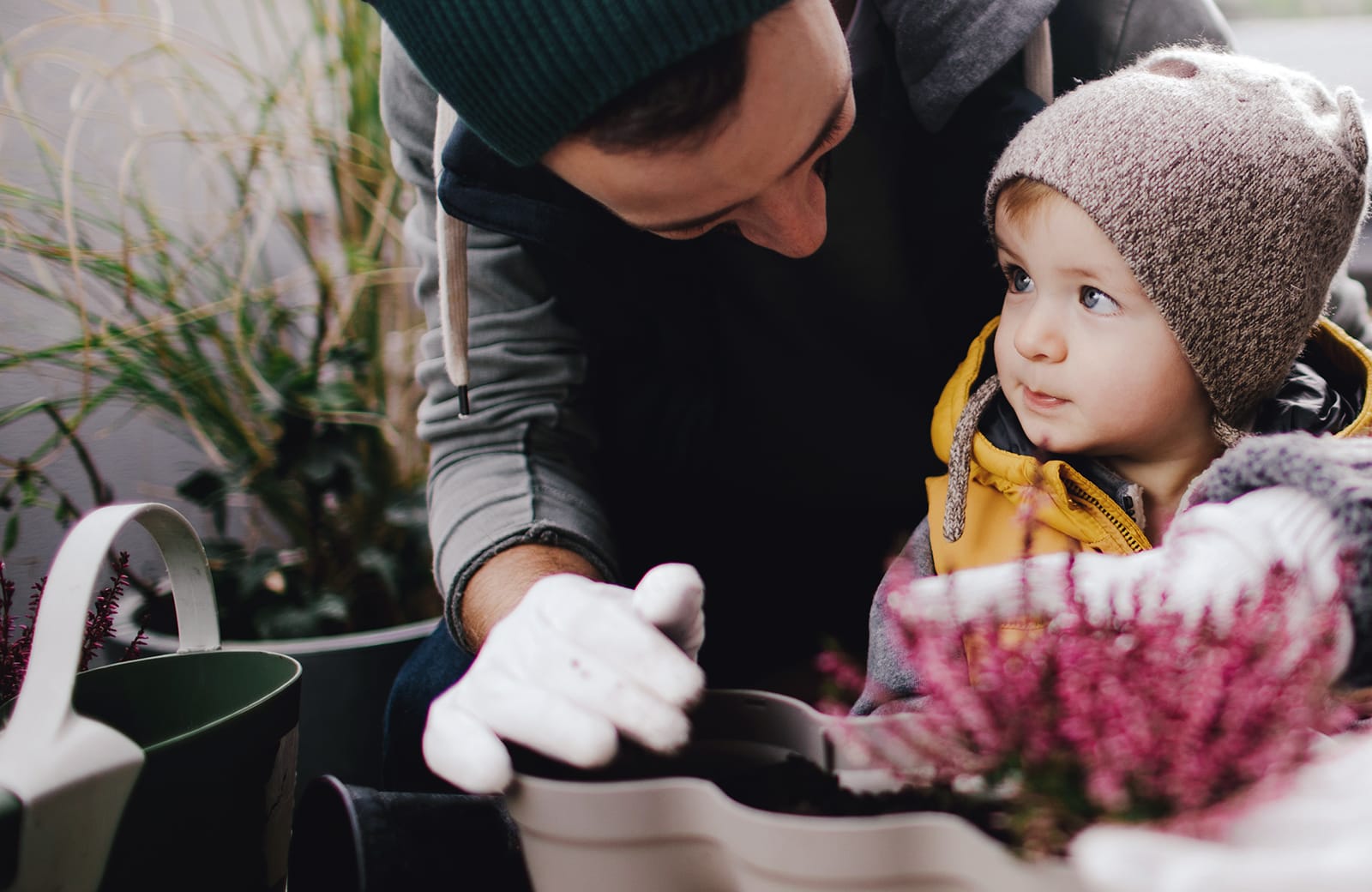 Parent looking at child while gardening